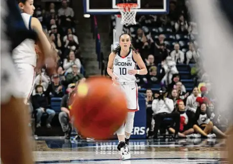  ?? Jessica Hill/Associated Press ?? UConn’s Nika Muhl runs backward after breaking UConn’s single-season assist record held previously by Sue Bird in the first half against Xavier on Monday in Storrs.