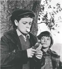  ?? UNIVERSAL PICTURES ?? Actors Phillip Alford, left, and Mary Badham learn some important life lessons in the 1962 film version of Harper Lee’s classic novel of racial injustice, To Kill a Mockingbir­d.