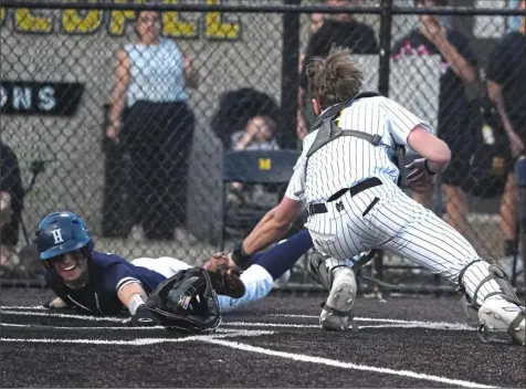  ?? ON THE WEB: post-gazette.com. Sebastian Foltz/Post-Gazette ?? Hopewell’s Zachary Gigliotti, left, scores ahead of the tag from Montour catcher Ryan Gamble Tuesday. Montour defeated Hopewell, 8-1. Complete results from Tuesday at