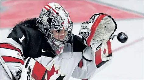  ?? JASON KRYK/THE CANADIAN PRESS ?? Canada goaltender Shannon Szabados makes a glove save during the Women’s World Hockey Championsh­ip, on March 31. Szabados is one of 28 players invited to try out for the 2018 Olympic women’s hockey team currently toiling in an 18-day boot camp in...