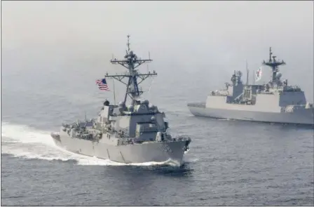  ?? MASS COMMUNICAT­ION SPECIALIST 3RD CLASS KELSEY L. ADAMS — U.S. NAVY VIA AP ?? In this Tuesday photo released by the U.S. Navy, the Arleigh Burke-class guided-missile destroyer USS Wayne E. Meyer, left, is underway alongside the Republic of Korea multirole guided-missile destroyer Wang Geon during a bilateral exercise.