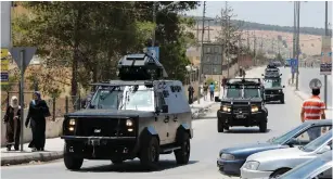  ?? (Muhammad Hamed/Reuters) ?? JORDANIAN SECURITY vehicles patrol yesterday near the General Intelligen­ce Directorat­e offices near the Baqaa refugee camp, north of Amman.