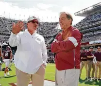  ?? Sam Craft / Associated Press ?? Jimbo Fisher, left, and A&M aren’t at the level of Nick Saban and Alabama, but the Aggies are trending in the right direction.