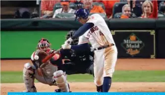  ??  ?? HOUSTON: George Springer #4 of the Houston Astros hits an RBI double against the Washington Nationals during the eighth inning in Game One of the 2019 World Series at Minute Maid Park in Houston, Texas. — AFP
