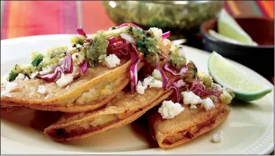  ?? Chicago Tribune/ MICHAEL TERCHA ?? Fried Potato Tacos are fi lled with potatoes and topped with Roasted Tomatillo Salsa, shredded cabbage and queso fresco.