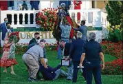  ??  ?? Trainer Bob Baffert was unharmed after being knocked down by his winning horse Authentic in the winner’s circle. Baffert described the horse as “a little flighty.”