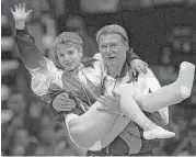  ??  ?? When Bela Karolyi reflects on his role in the sport since the 1960s, he recalls some of the great gymnasts he has coached. They include Kerri Strug, above, as she completed her 1996 Olympics run injured en route to a U.S. team gold medal and Mary Lou...