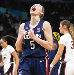  ?? CHARLIE NEIBERGALL/AP ?? Paige Bueckers had 14 points, five assists and two steals as the Huskies knocked out defending women’s NCAA champion Stanford 63-58 on Friday night in the national semifinals at Minneapoli­s.