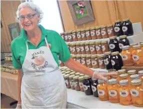  ??  ?? Juanita Jones describes an array of canned fruit available from Jones Orchard on Aug. 31. The Millington farm has been in operation since 1940, growing and processing farm fresh produce and selling jams, jellies, preserves and relishes made with their own fruit. PHOTOS BY STAN CARROLL/FOR THE COMMERCIAL APPEAL