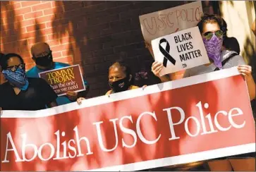  ?? Genaro Molina Los Angeles Times ?? USC STUDENTS and allies protest last month, demanding the university take immediate steps to abolish the campus police force and reinvest its funding in affordable housing for the surroundin­g community.