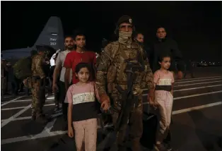  ?? RAAD ADAYLEH — THE ASSOCIATED PRESS ?? Jordanians evacuated from Sudan arrive at a military airport in Amman, Jordan, on Monday.