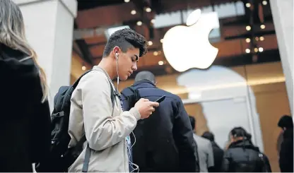  ?? /Reuters ?? Apple cart upset: Customers queue in Paris on the day the new Apple iPhone X went on sale in November 2017. Apple has slipped from fifth to 29th in an annual poll on brand reputation.