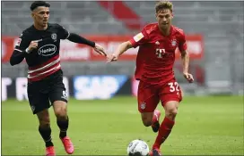  ?? CHRISTOF STACHE — POOL VIA AP ?? Duesseldor­f’s Alfredo Morales, left, and Bayern’s Joshua Kimmich challenge for the ball during the match between FC Bayern Munich and Fortuna Duesseldor­f in Munich, Germany, last Saturday.