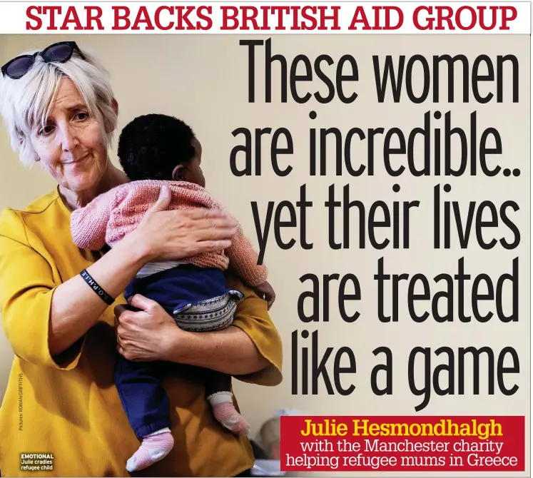  ?? ?? EMOTIONAL Julie cradles refugee child