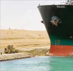  ?? SUEZ CANAL AUTHORITY ?? The cargo ship Ever Given sits with its bow stuck into the wall Wednesday after it become wedged across Egypt’s Suez Canal and blocked all traffic in the vital waterway.