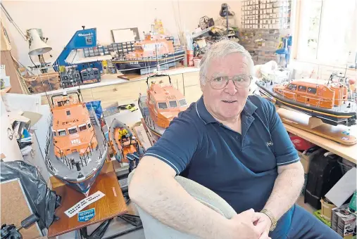  ?? Photograph­s by Sandy McCook ?? ENTHUSIAST: Ted Miller with some of his hand-crafted lifeboat models which he has built over the past 25 years.