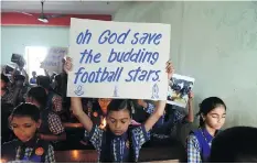  ?? SAM PANTHAKY/AFP/GETTY IMAGES ?? Schoolchil­dren in Ahmedabad, India, hold placards Monday during a prayer for the rescue of the Thai soccer team that’s stuck in a cave.