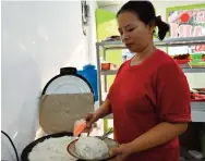  ??  ?? An Indonesian food vendor dishing out a plate of rice in Jakarta