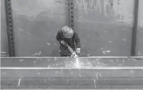  ??  ?? An employee works on a portion of the new Champlain Bridge. Five per cent of Canam’s part of the work is complete. The total tab for the bridge is expected to be $4 billion.