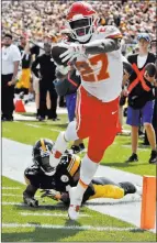  ?? Gene J. Puskar ?? The Associated Press Chiefs running back Kareem Hunt (27) gets away from Steelers defensive back Terrell Edmunds with one of six touchdown passes thrown by Patrick Mahomes in Kansas City’s 42-37 victory Sunday at Pittsburgh.