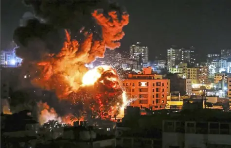  ?? Mahmud Hams/AFP/Getty Images ?? Fire and smoke billow above buildings in Gaza City during reported Israeli strikes on Monday.