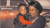  ??  ?? DILLAN HARRIS, pictured with an unnamed relative, was killed in Chicago in July after a car speeding away from a homicide struck him. He was 1 year old.
