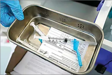  ?? WILFREDO LEE / AP FILE ?? This May 13 file photo shows syringes filled with the Johnson & Johnson vaccine at a mobile vaccinatio­n site in Miami. Police department­s that are requiring officers to be vaccinated against COVID-19 are running up against pockets of resistance across the United States.