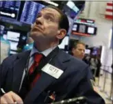  ?? RICHARD DREW — THE ASSOCIATED PRESS ?? Trader Tommy Kalikas works on the floor of the New York Stock Exchange, Thursday. Stocks tumbled Thursday on Wall Street, with technology companies suffering their worst loss in seven years, after Apple reported that iPhone sales are slipping in China.