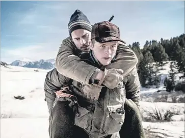  ?? Stanislav Honzik IFC Films ?? JOSH WIGGINS as David carries his father, Cal (Matt Bomer), out of the wilderness in “Walking Out.”