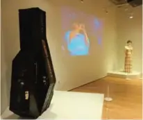  ??  ?? Photo shows a jazz exhibition in Newark, NJ, with Ella Fitzgerald performing on video next to the gown she was wearing.