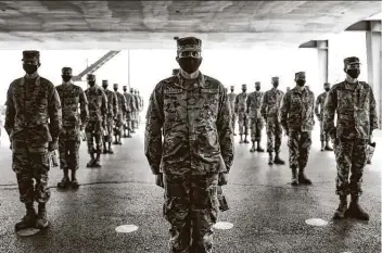  ?? Billy Calzada / Staff photograph­er ?? Some of the 708 basic military training graduates prepare to enter the Barnes Training Complex cafeteria at Lackland. Meals usually are eaten in silence, but on this day, the graduates were encouraged to socialize.