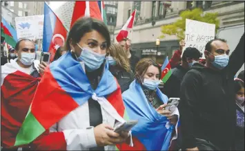  ?? VERONICA HENRI/POSTMEDIA NEWS ?? Protesters march in downtown Toronto on Sunday to draw atention to the NagornoKar­abakh conflict between Azerbaijan and Armenia.