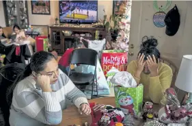  ??  ?? Jessie Taken Alive- Rencountre, left, and her sister Nola Taken Alive, whose parents died a month apart from the coronaviru­s, are pictured on Christmas Day in McLaughlin, S. D.