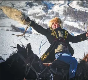  ??  ?? A Hemu villager participat­es in the traditiona­l sport of buzkashi, or “sheep pulling”, which is performed for tourists.