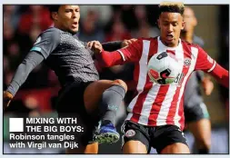  ??  ?? ■
MIXING WITH THE BIG BOYS: Robinson tangles with Virgil van Dijk