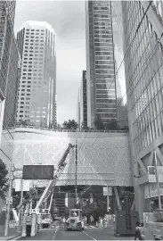  ?? Michael Cabanatuan / The Chronicle ?? Workers unload hydraulic jacks to be used for support at the Transbay Transit Center.