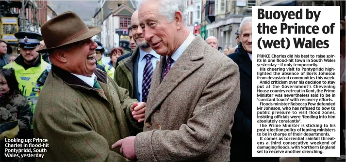 ??  ?? Looking up: Prince Charles in flood-hit Pontypridd, South Wales, yesterday