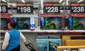  ?? Photograph: Bloomberg/Getty Images ?? A worker stocks television­s at a Walmart store on Black Friday in Secaucus, New Jersey, on 24 November.