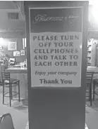  ?? EDWARD C. BAIG/USA TODAY ?? A sign at Flavours restaurant in Pittsfield, Mass., implores customers to put away their phones.