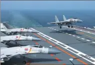  ?? LI TANG / FOR CHINA DAILY ?? A J-15 carrier-borne fighter jet lands on CNS Liaoning during a military exercise last month.