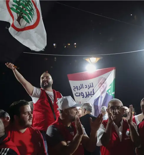  ?? Reuters; AFP ?? Clockwise from above, Christian Lebanese Forces party supporters; opposition candidate Firas Hamdan took a seat from Hezbollah; a poster for independen­t candidate Elias Jradeh; supporters of Hezbollah and the Amal Movement ride in a convoy