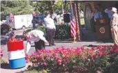  ?? Photo courtesy of Beth Aday ?? A member of the American Legion Stephen M. Brammer Post 705 places an unservicea­ble flag into a burn barrel during the organizati­on’s inaugural flag retirement ceremony at Sutter Cemetery on Monday.