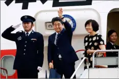  ??  ?? Japanese Prime Minister Shinzo Abe, center, and his wife Akie prepare to leave for the U.S. at Haneda Internatio­nal Airport in Tokyo Wednesday. HIrokI YamaucHI/kYodo News VIa aP