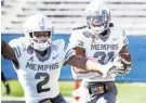  ?? MARK ?? Memphis defensive back Chris Claybrooks (right) celebrates an intercepti­on return for a touchdown with TJ Carter (left) against Wake Forest during action in the Birmingham Bowl last season. WEBER / THE COMMERCIAL APPEAL