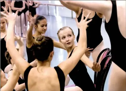  ?? Arkansas Democrat-Gazette/JOHN SYKES JR. ?? Clara, played by Izzi Rhodes (center), is surrounded by other community cast members during a rehearsal for Ballet Arkansas’ production of The Nutcracker.