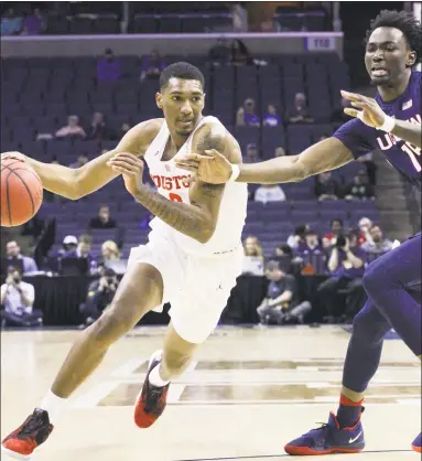  ?? Troy Glasgow / Associated Press ?? Right, Houston’s Armani Brooks drives around UConn’s Sidney Wilson during the AAC quarterfin­als on Friday in Memphis, Tenn. The top-seeded Cougars beat the Huskies, 84-45.