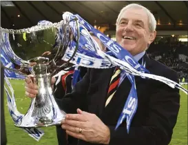  ??  ?? A grinning Walter Smith claims the CIS Cup for Rangers in 2008