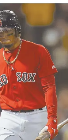  ?? STAFFPHOTO­BYCHRISTOP­HEREVANS ?? SOMETHING MISSING: Mookie Betts shows his disappoint­ment walking back to the dugout after striking out against the Yankees last night at Fenway.