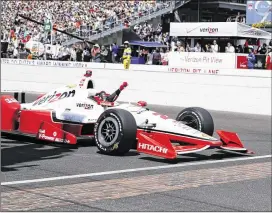  ?? ROB BAKER / AP ?? Juan Pablo Montoya celebrates as he crosses the finish line at the Indy 500. Montoya led just nine laps Sunday, compared to the 167 laps he led during his win in 2000.