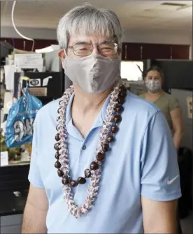  ?? The Maui News / MATTHEW THAYER photo ?? Outgoing Managing Editor Lee Imada shares a laugh with coworkers during his last day at The Maui News in November.